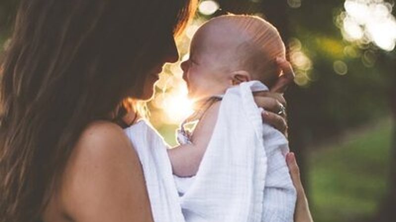 A mother holding her newborn baby